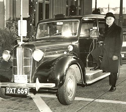 Sid Thal outside his London taxi.