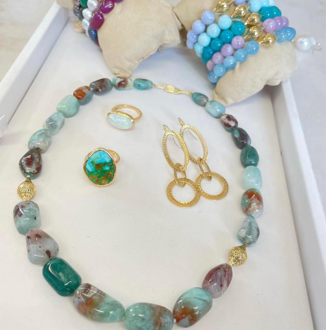 tray of colorful gold jewelry