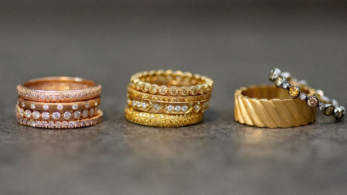 stacks of yellow and rose gold and diamond rings