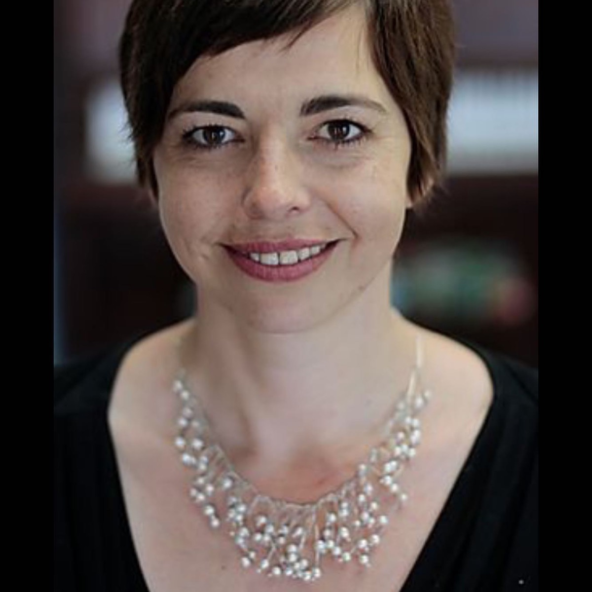 woman with large necklace on