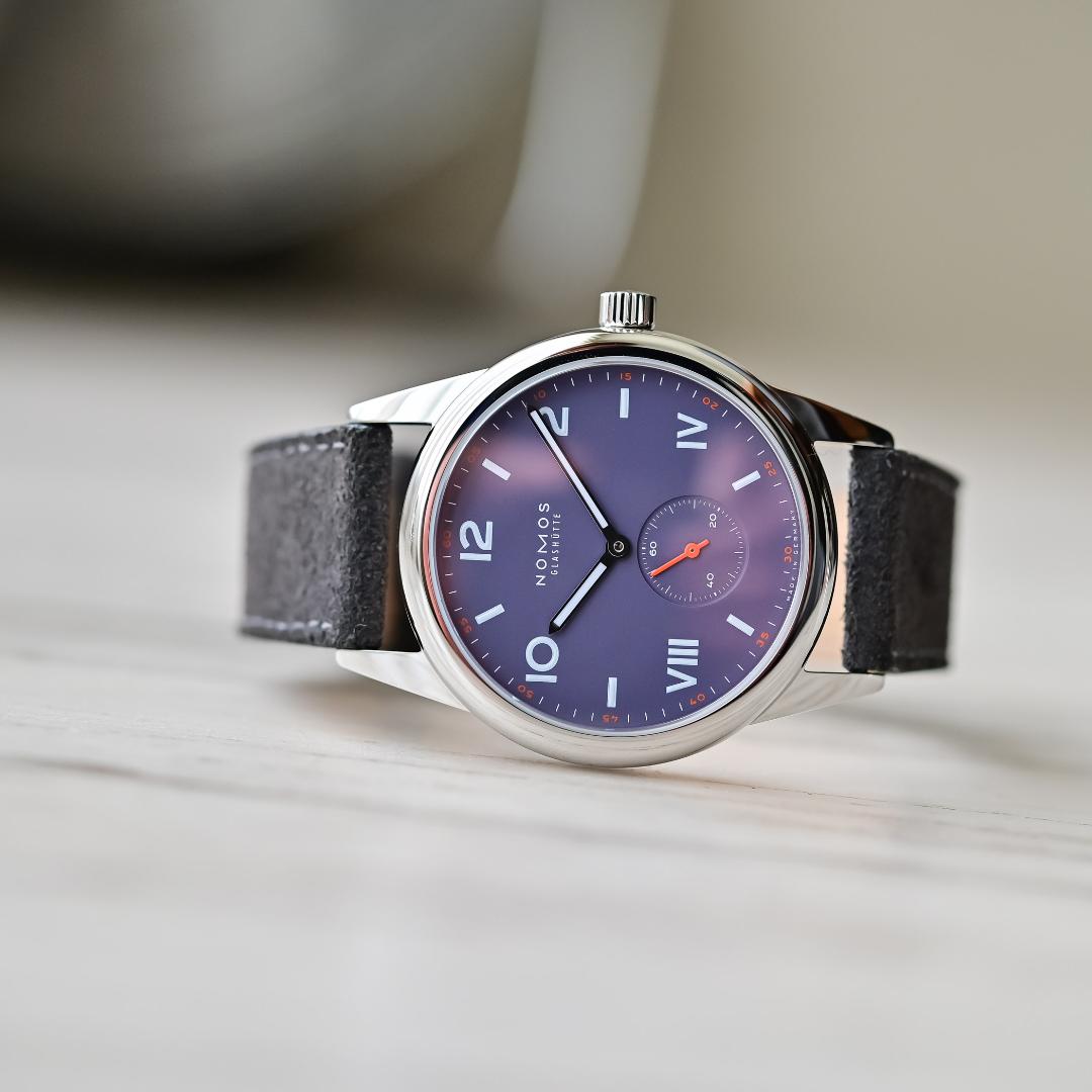 Photo of a watch with a dark purple face.