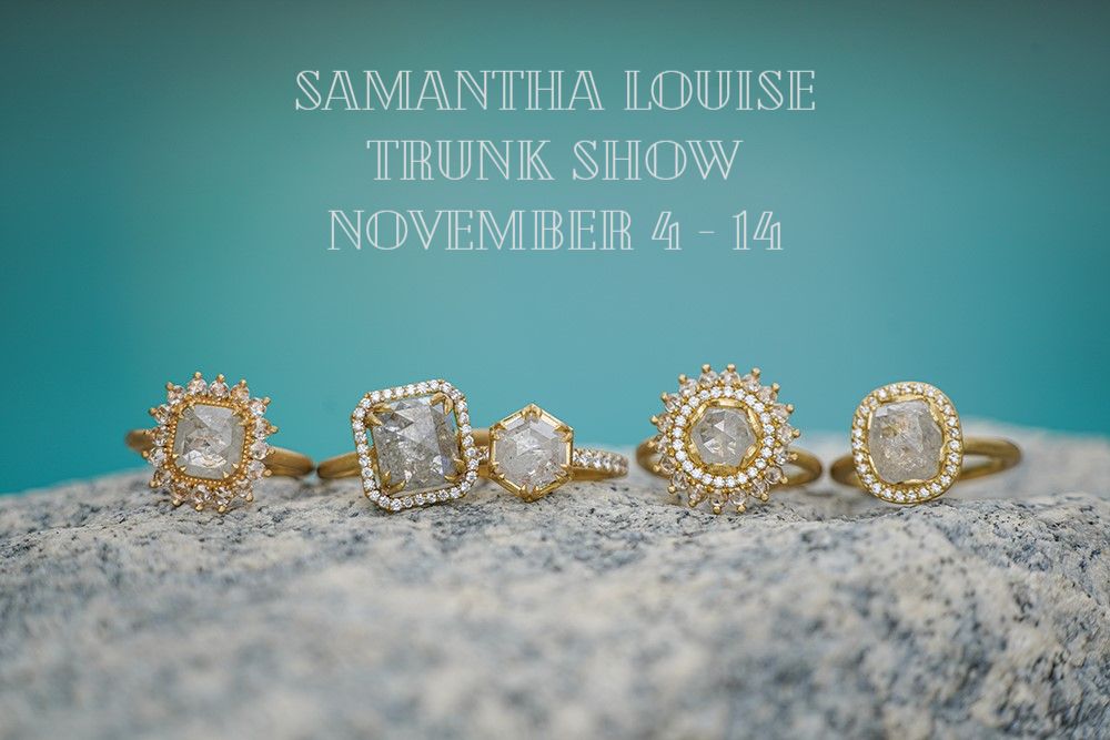 Samantha Louise rings on concrete with blue background and "Samantha Louise Trunk Show November 4-14" written