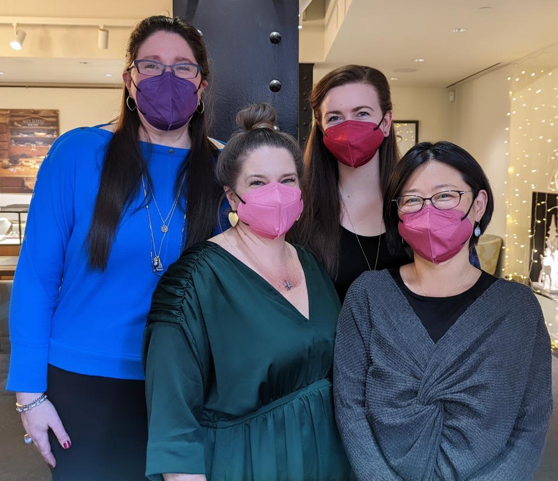 4 women wearing colorful masks