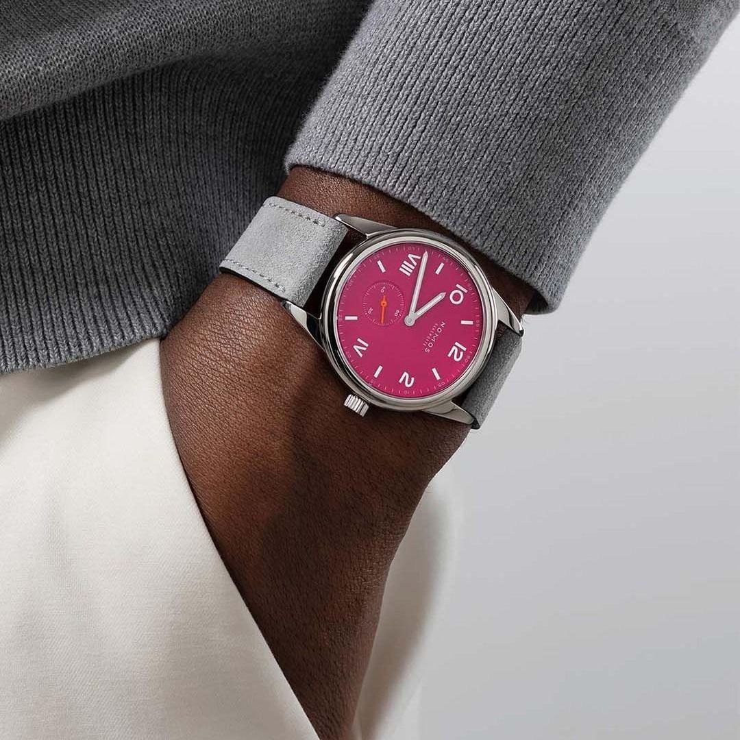 Pink face Nomos watch on a wrist