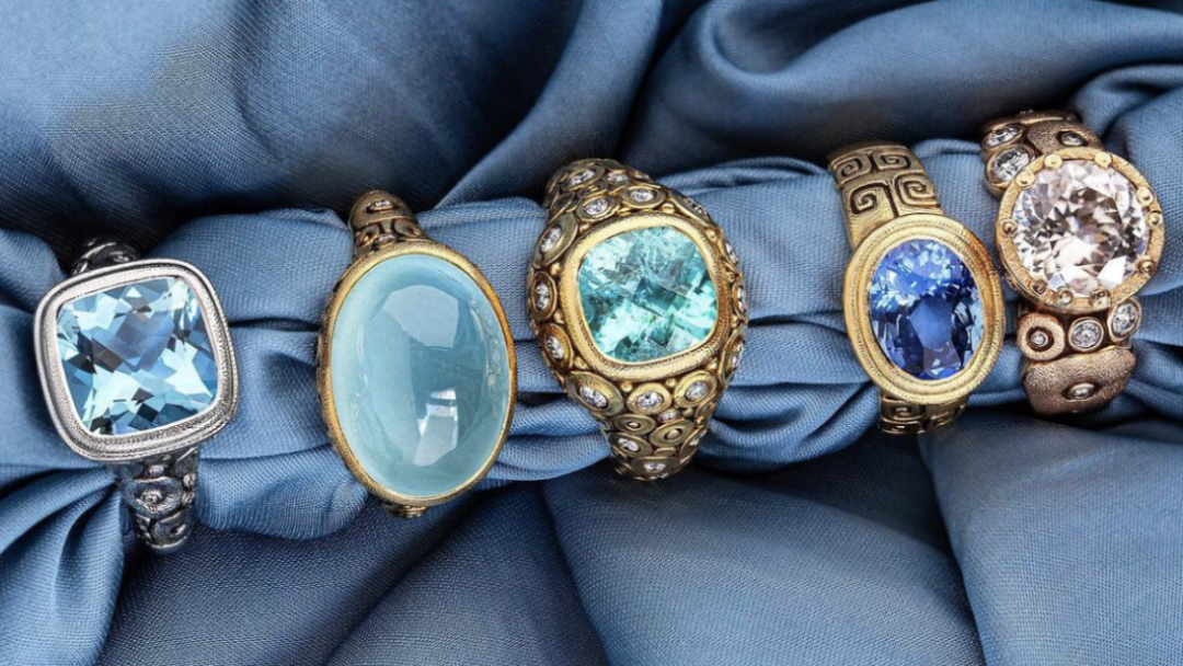 Blue gemstone rings on blue background