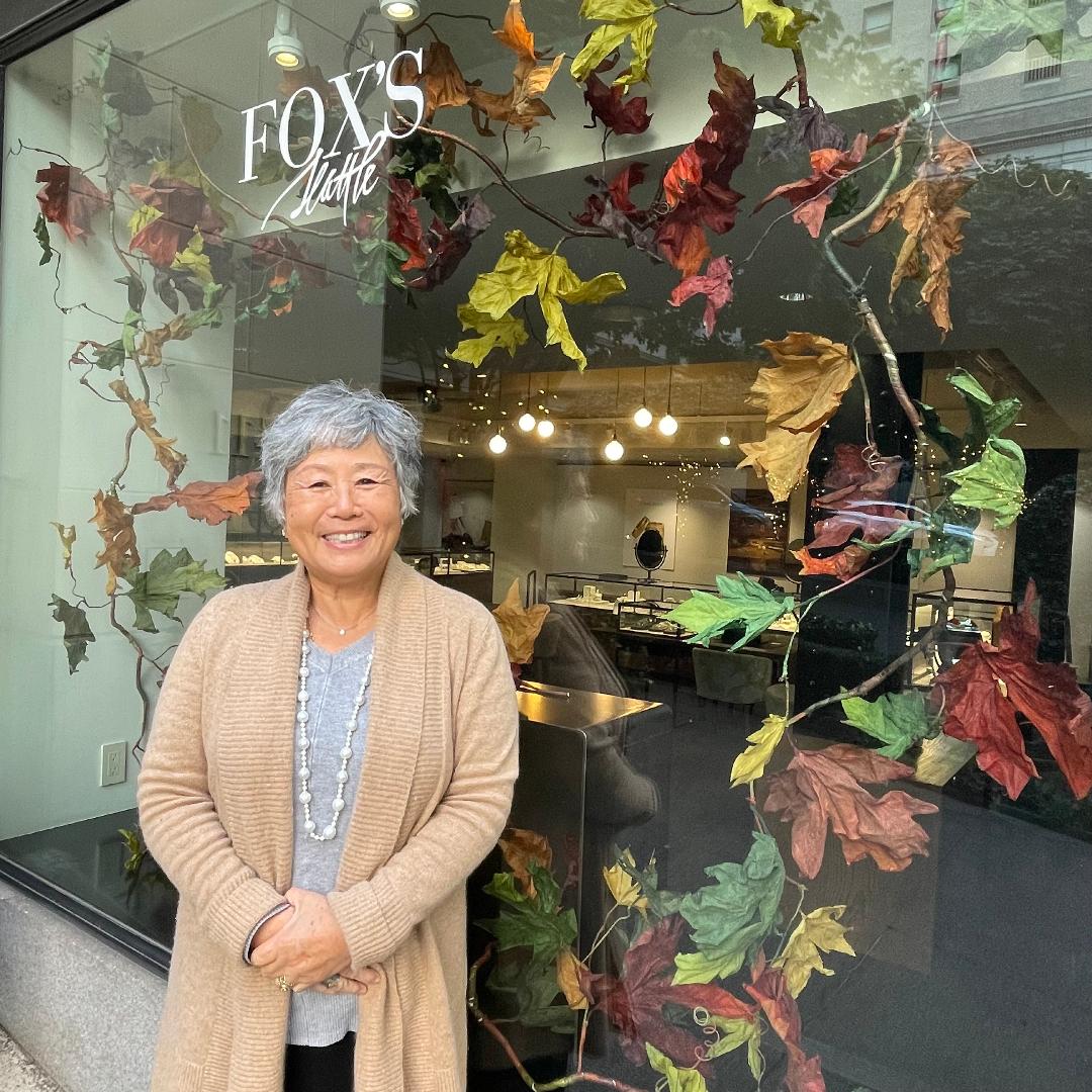 Photo of a woman standing in front of the shop window