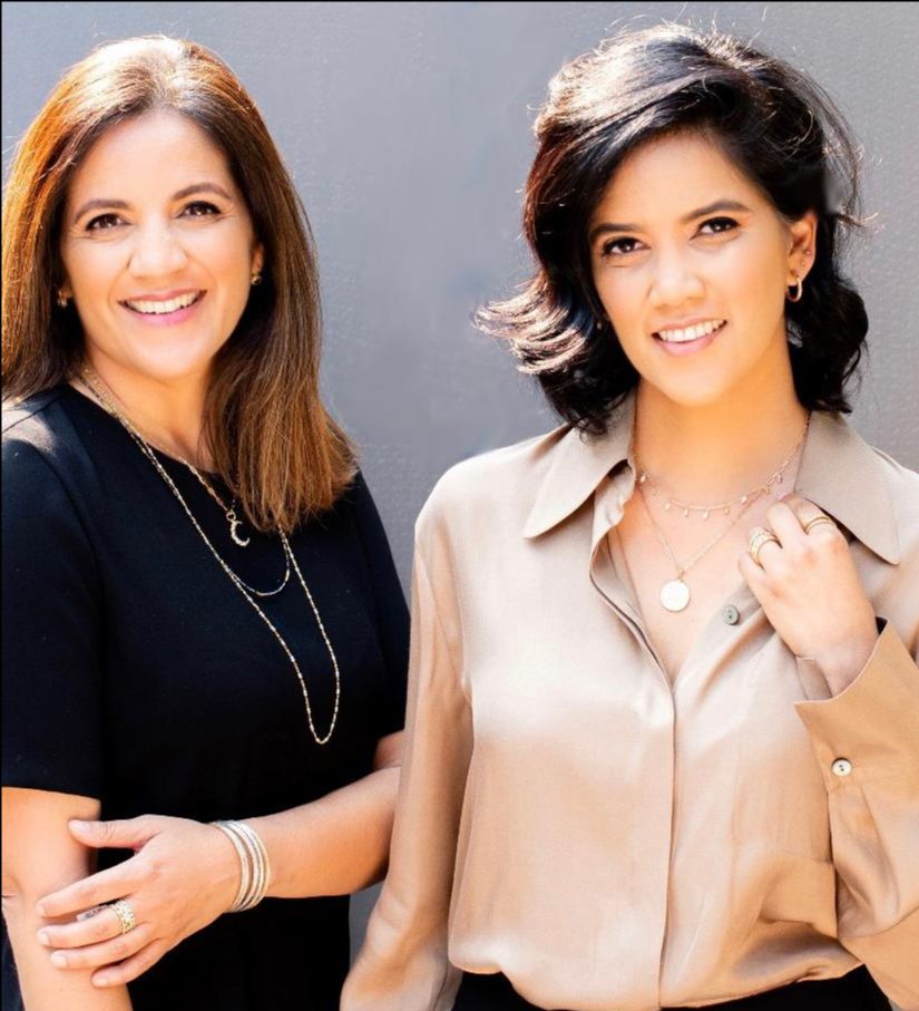 two women with lots of jewelry smiling at the camera
