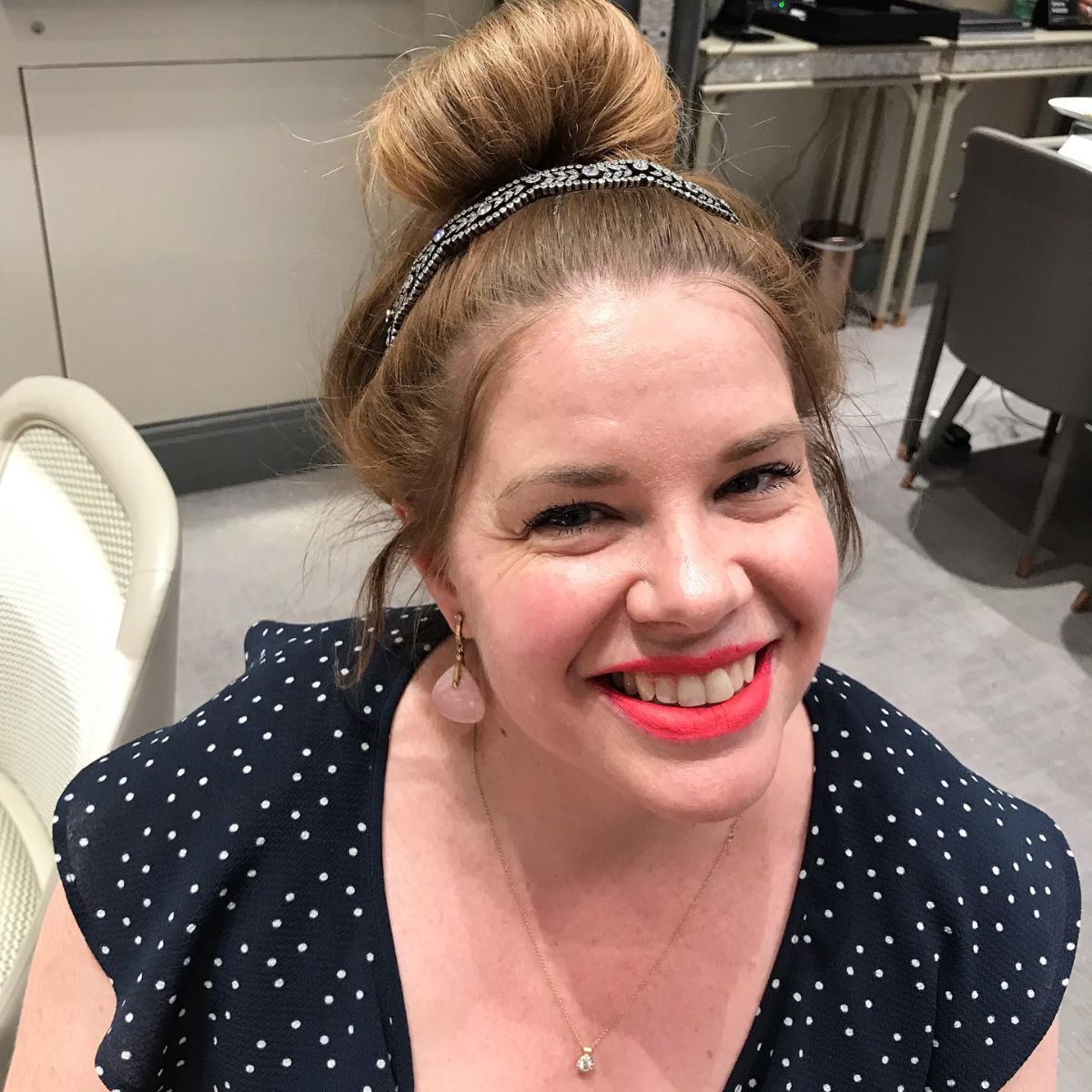 Photo of a woman wearing a tiara and looking up