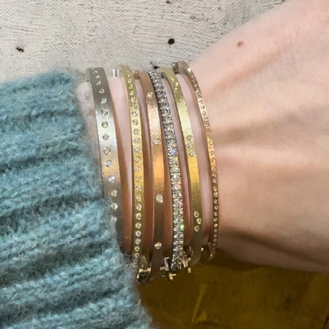 wrist shot with blue fuzzy sweater and diamond bangle bracelets in yellow, white and rose gold