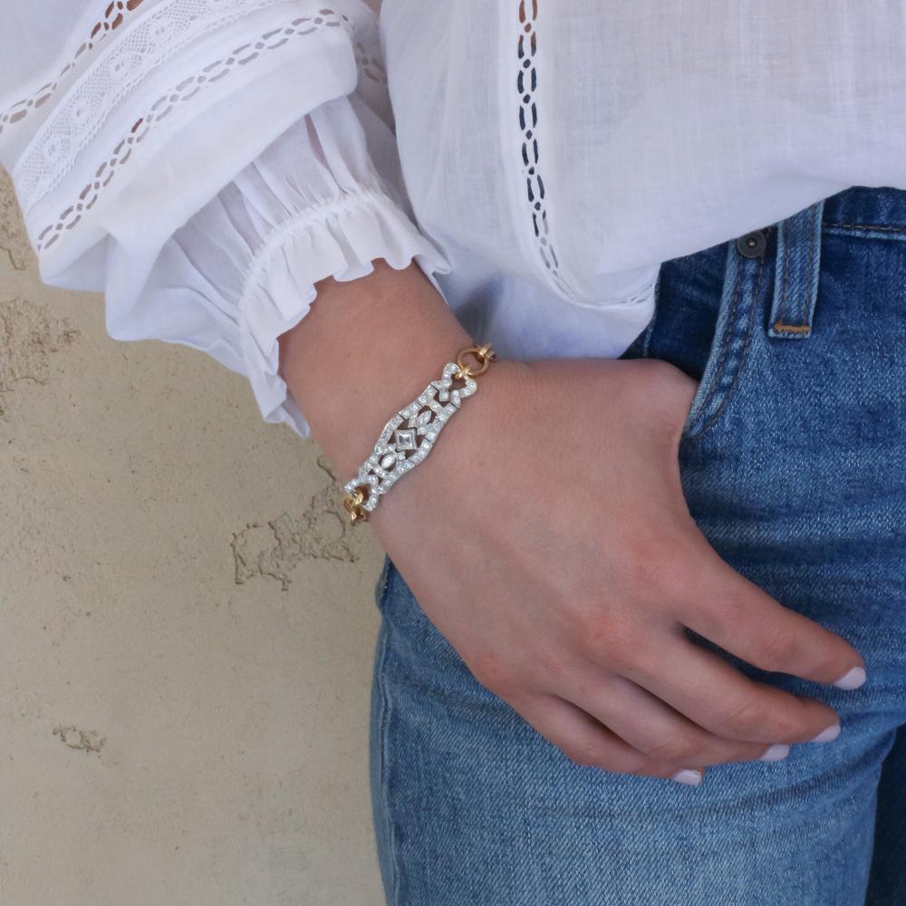 woman with blue jeans and white shirt with bracelet on arm