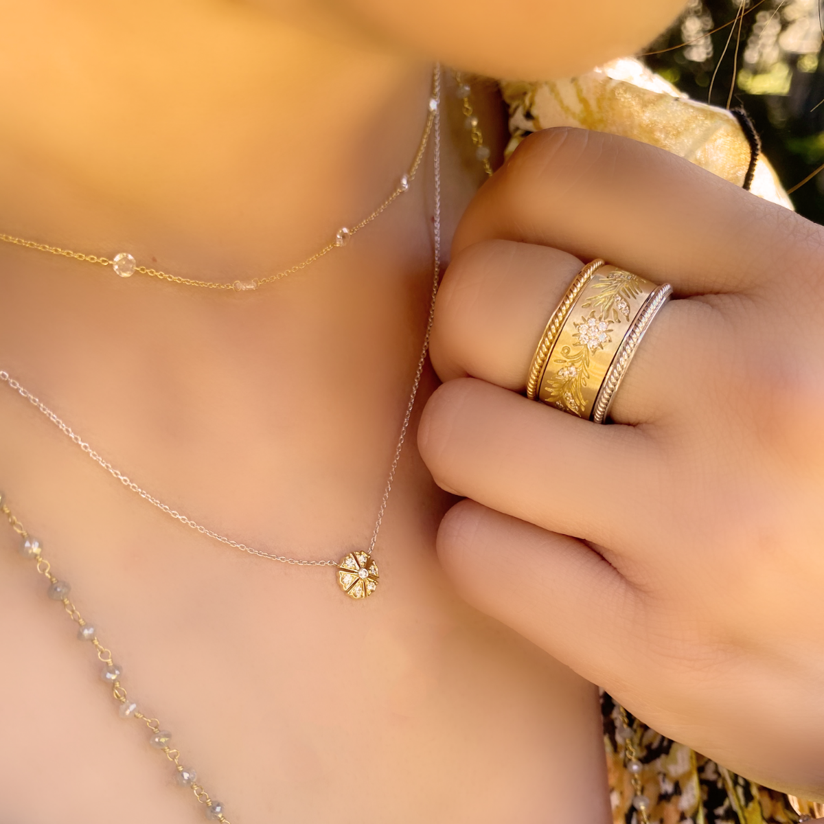 Woman's neck and hand with jewelry on it