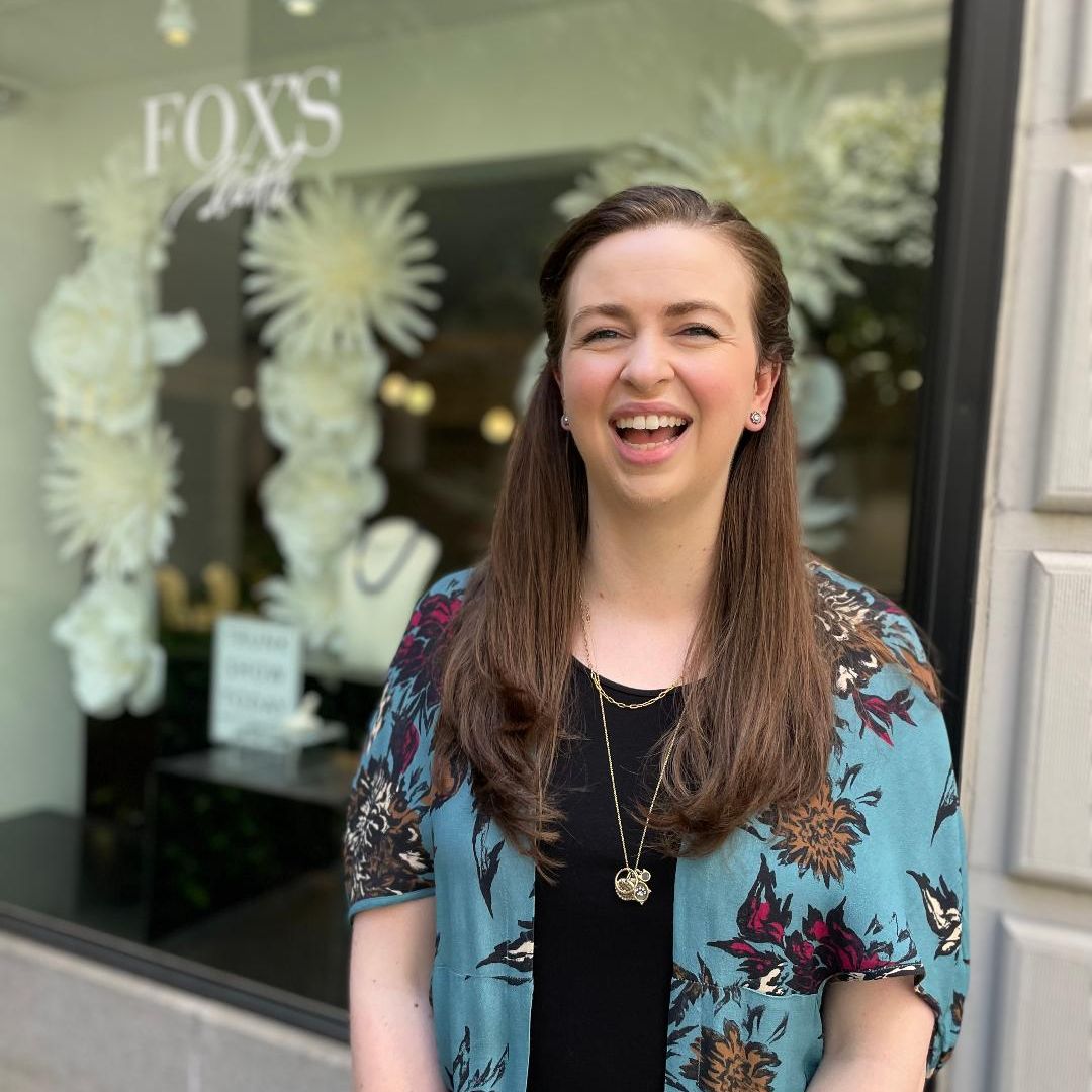 woman with long brown hair smiling in front of Fox's window