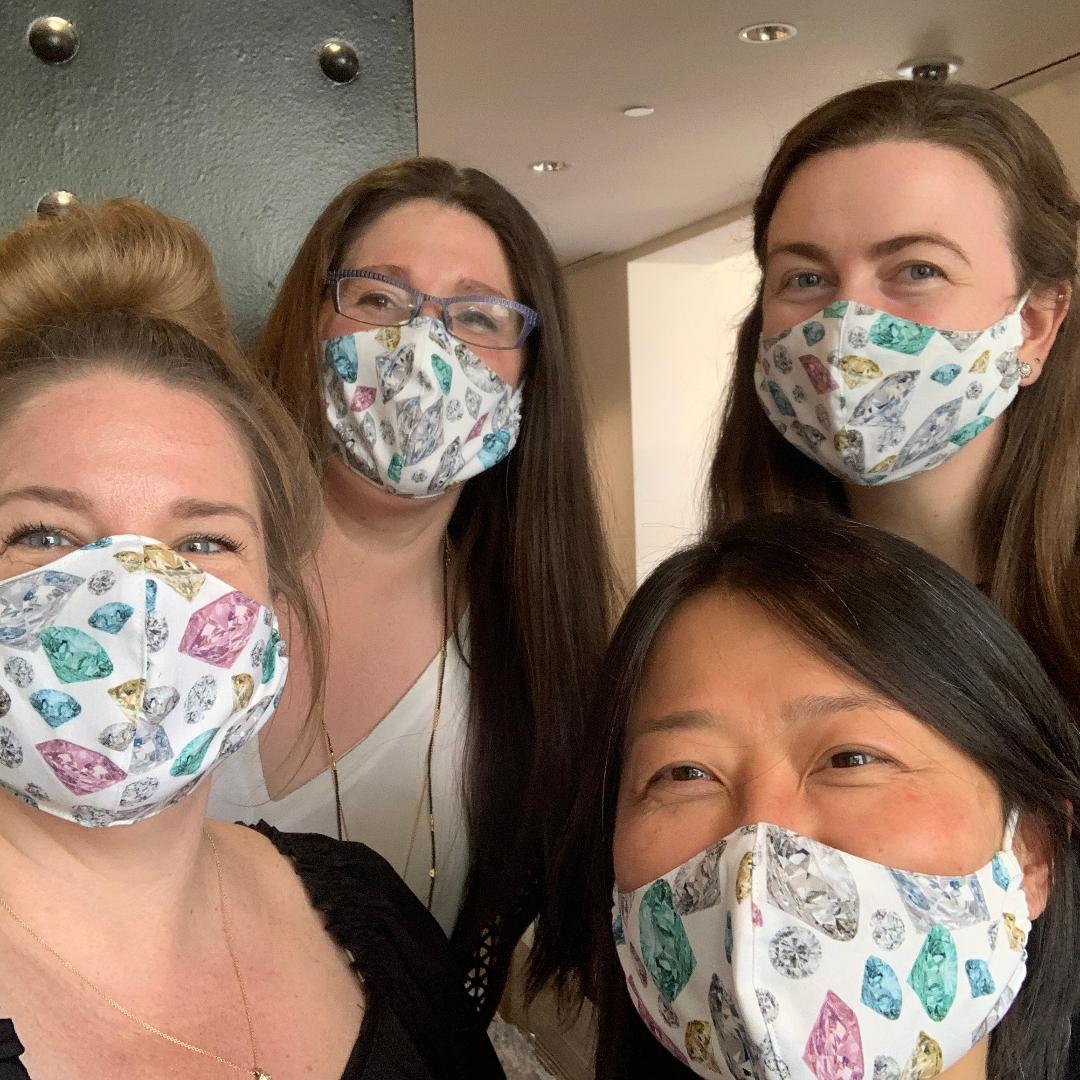 4 women with diamond patterned face masks on