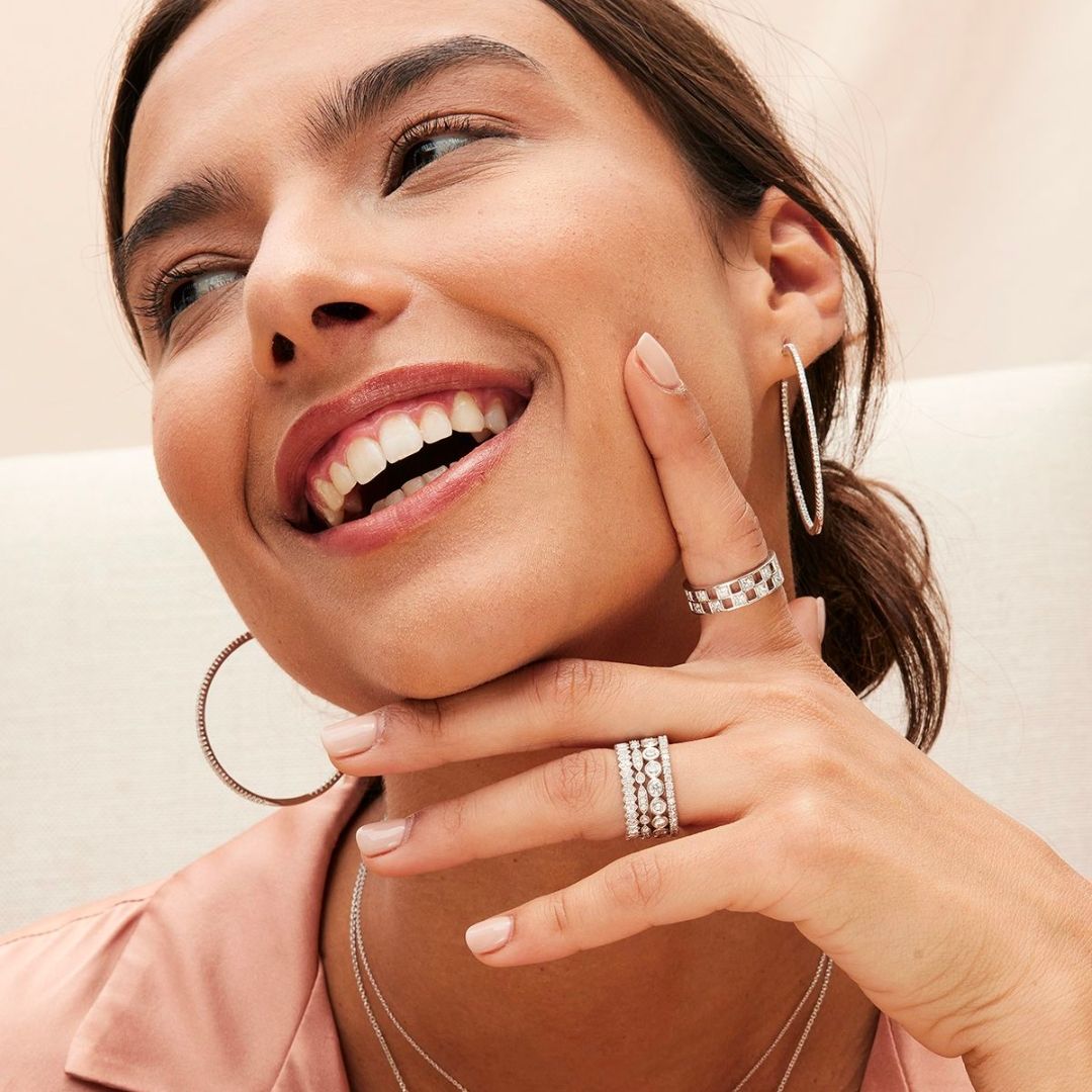 Woman laughing with lots of jewelry on