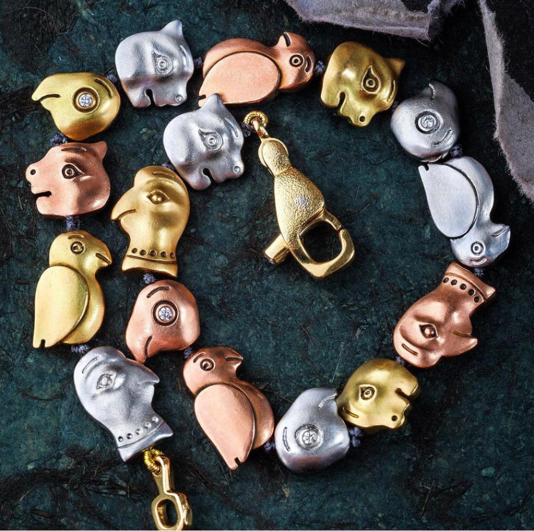 Photo of yellow gold, rose gold and palladium creature bracelet.