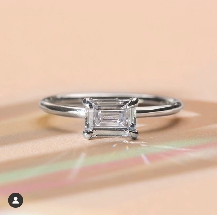 ILA 18k white gold engagement ring emerald cut set east west.