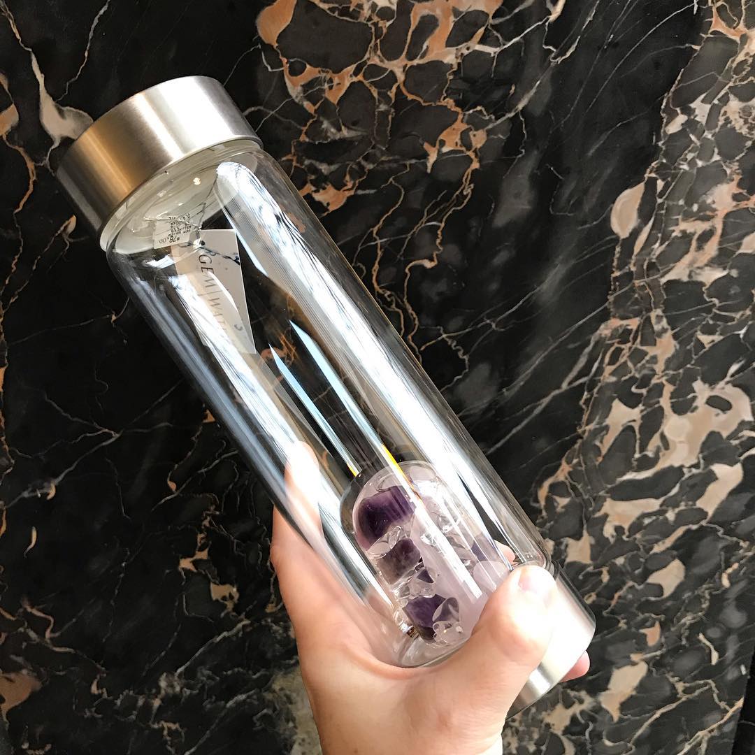 Wellness water bottle against black marble background