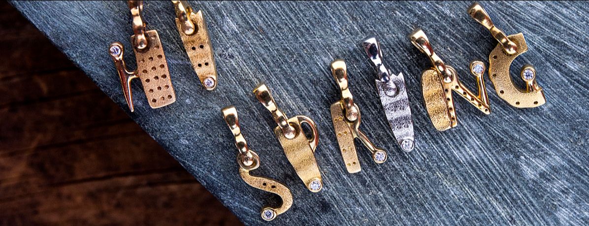 Alex Sepkus pendants spelling "Hi Spring" link takes you to see all Alex Sepkus letters on his website.