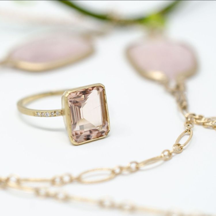 Yellow gold and morganite ring with pink stone necklace in the background