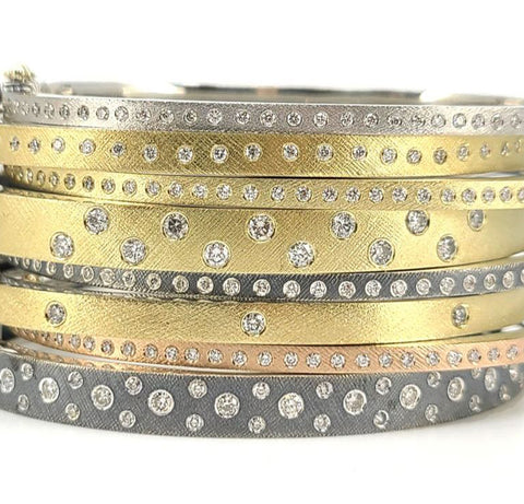 Stack of yellow, white, rose and silver bangles with diamonds