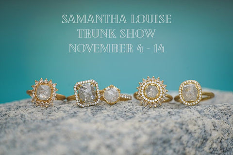 Samantha Louise rings on concrete with blue background and "Samantha Louise Trunk Show November 4-14" written