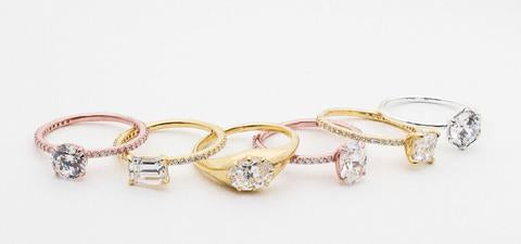 6 engagement rings in rose, white, and yellow gold with a variety of shaped diamonds and either a plain band or pave diamond band