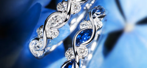 Diamond and sapphire rings on blue background