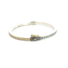side angle of Rene Escobar 18k yellow gold "Adam" diamond bangle bracelet with silver backside