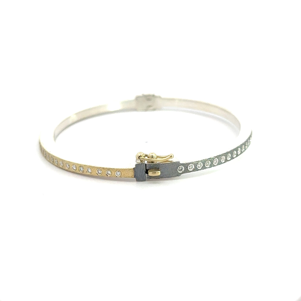 side angle of Rene Escobar 18k yellow gold "Adam" diamond bangle bracelet with silver backside