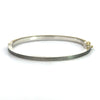 back side of Rene Escobar 18k yellow gold "chloe" diamond bangle bracelet with diamonds on front and a sterling silver back
