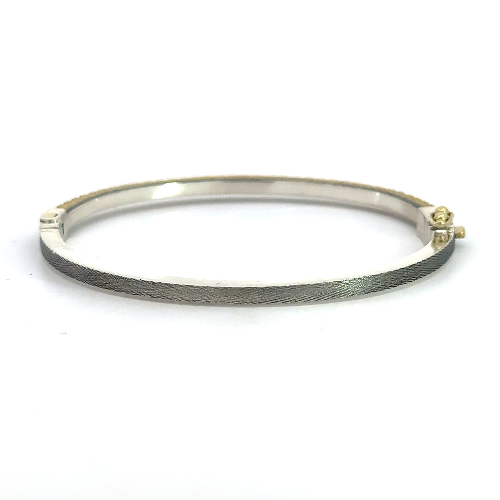 back side of Rene Escobar 18k yellow gold "chloe" diamond bangle bracelet with diamonds on front and a sterling silver back