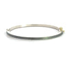 back side of Rene Escobar 18k rose gold "maru" diamond bangle bracelet with diamonds on front in groups of 3 and a silver back