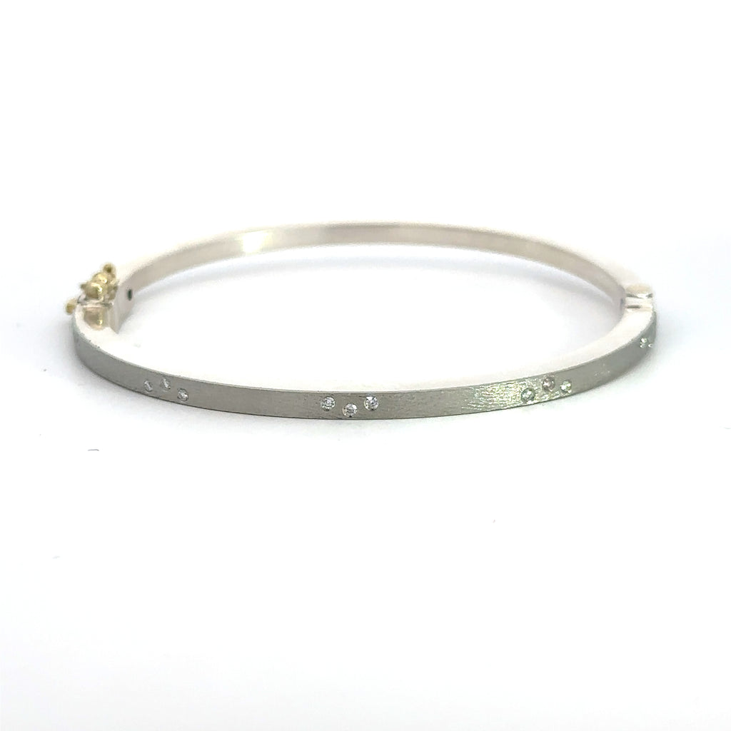 Rene Escobar 18k white gold "maru" diamond bangle bracelet with diamonds on front in groups of three