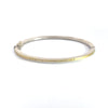 Rene Escobar 18K Yellow Gold and Sterling Silver "Laura" Diamond Bangle Bracelet featuring diamonds in a row on one side.