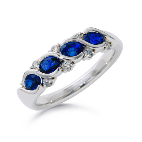 Suwa platinum anniversary style band with four oval sapphires and eight round brilliant diamonds