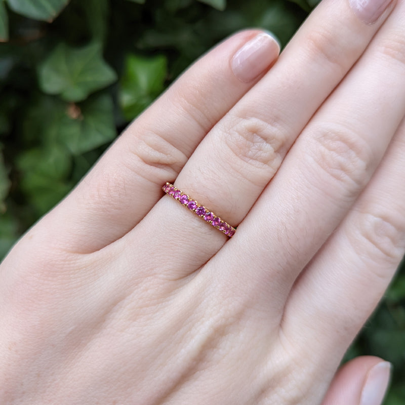 18K Rose Gold Pink Sapphire Eternity Band on hand