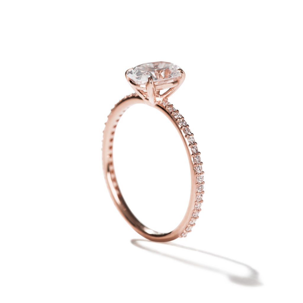 rose gold engagement ring with pave diamonds and a large oval diamond ring