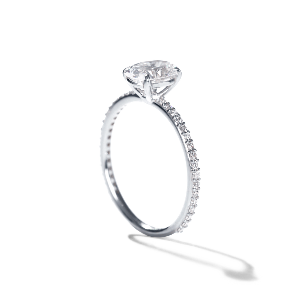 white gold ILA ring with pave diamonds along the rim and large diamond centerpiece