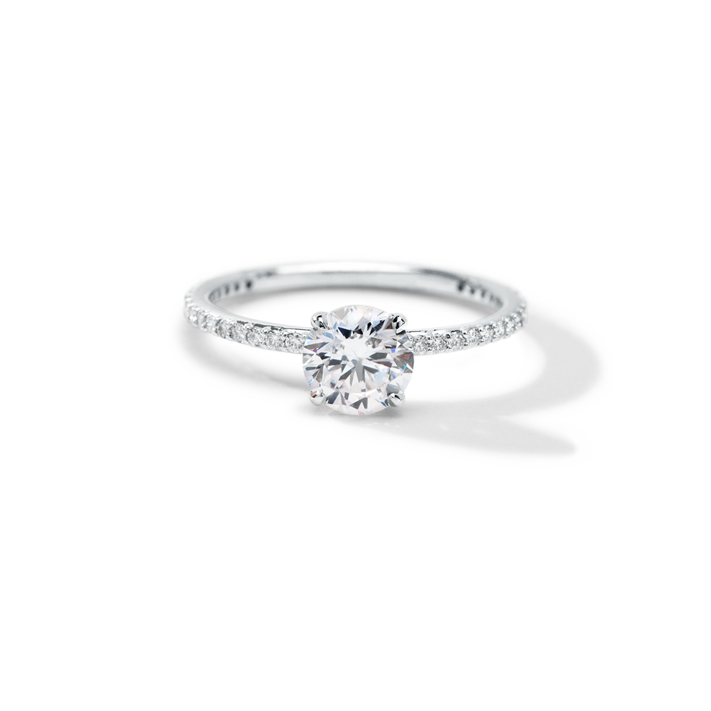ILA Solitaire engagement ring with pave diamonds covering the full visible surface and a large round cut diamond