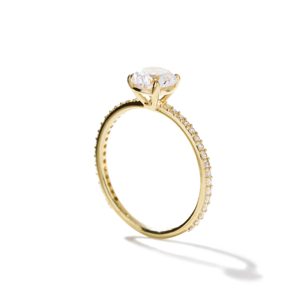 ILA Solitaire yellow gold ring with large diamond and pave diamonds along rim