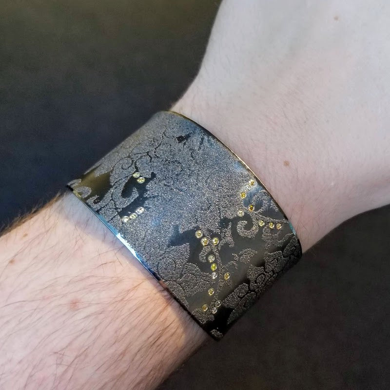 Atelier Zobel large green cuff with paisley design  on arm