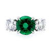 Bayco Jewels platinum ring centering a round 2.42 carat Zambian emerald flanked by round brilliant cut colorless diamonds