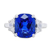 Bayco Jewels platinum ring centering a 5.11 carat cushion-shaped Madagascar sapphire flanked by two half moon diamonds