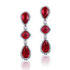 Bayco Jewels 18 karat blackened gold dangle earrings each set with a cushion-shaped Mozambique ruby set between two pear-shaped Mozambique rubies, all surrounded by micropavé set diamonds