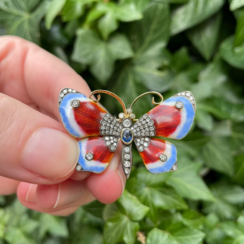 18K yellow gold, blue-red enamel, diamond and sapphire butterfly brooch, green leaf background