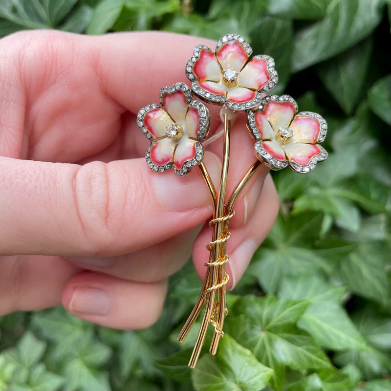 18K yellow gold, red-white enamel and diamond three flower bouquet brooch, green leaf background