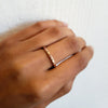 18K rose gold narrow "Dunes" eternity band with multi-color diamonds on hand
