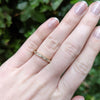 18K yellow gold channel set baguette diamond eternity band on hand