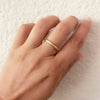 18K yellow gold narrow "Dunes" diamond eternity band on hand