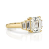 Caroline ring featuring a 1.54ct I/VVS2 GIA certified emerald cut diamond with 0.40ctw baguette cut accent diamonds set in an 18K yellow gold mounting, 3/4 view.